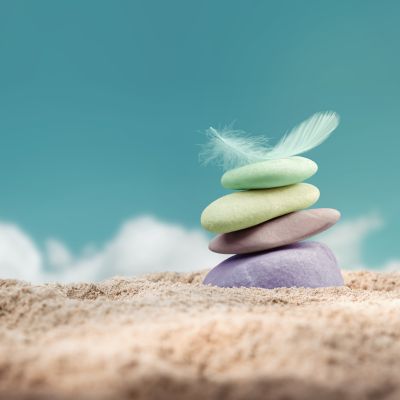 feather balanced on stone metaphor