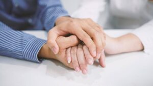 supporting hands together home caregiver support