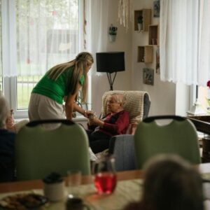 Home caregiver rubbing temples soft light